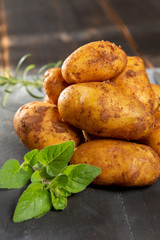 New harvest potatoes not washed with soil on table