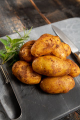 New harvest potatoes not washed with soil on table