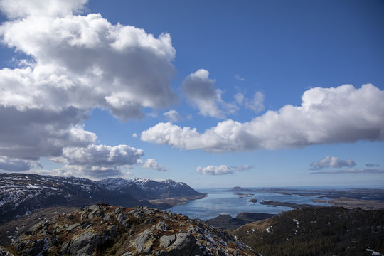 Blue skies and white clouds in great spring  weather on Bronnoy mountain in Northern Norway