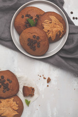 Vegan aquafaba peanut butter cookies with carob and chocolate drops, top view. Healthy vegan food concept.