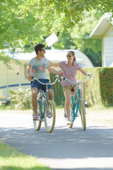Fototapeta premium Couple cycling arms around each other