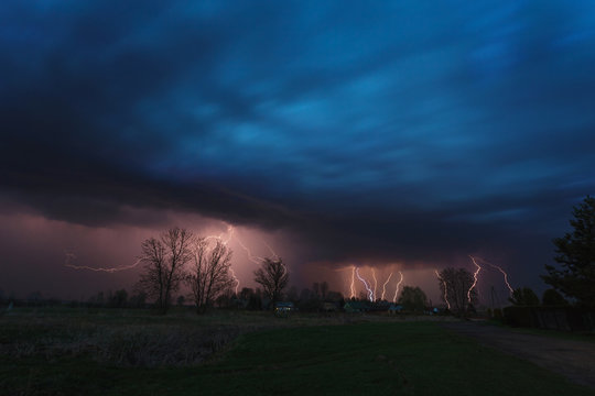 Multiple lightning strikes under dramatic sky