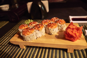 rolls with salmon on wooden Board