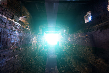 Dark tunnel or underground corridor with light in the end, hope to freedom and exit to light concept