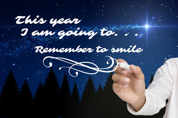 Businessman about to write something against shooting star over forest at night