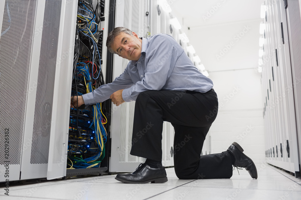 Poster man fixing server wires