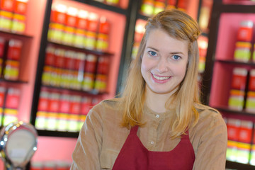 portrait of happy female seller in pharmaceutical store