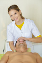 Obraz na płótnie Canvas man receiving head massage in medical office
