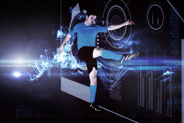 Fototapeta na wymiar Football player in blue kicking against abstract glowing black background