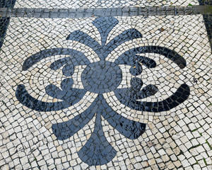 wet black and white pavement in lisbon, portugal