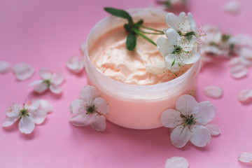 Obraz na płótnie Canvas hand cream with petals