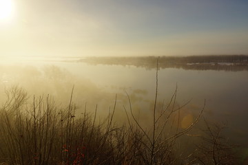 Fototapeta na wymiar morning spring fog over the river rises the sun is melting snow beautiful scenery