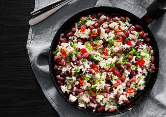 rice with red beans and vegetables in a frying pan