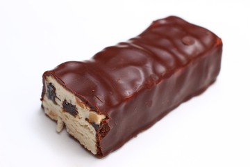 Cut chocolate bar on white background closeup