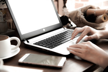 Women hand using touch pad on laptop in coffee shop with path