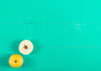 Fresh yellow apples on wooden background