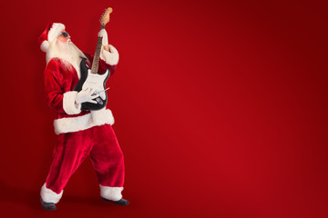 Santa playing electric guitar against red background