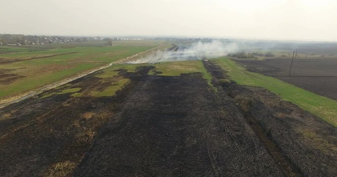 Aerial view of burning fields with stubble. 4K