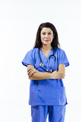 Vertical portrait of a female nurse or doctor in blue uniform with arms crossed, isolated on white studio background