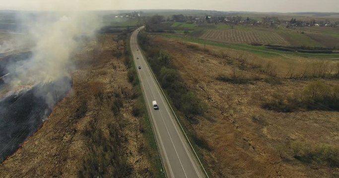 Aerial view of non-urban landscape, road and fields in 4K