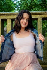 beautiful young girl pulls aside her jacket