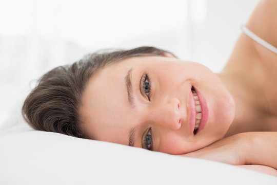 Close up portrait of a pretty woman in bed