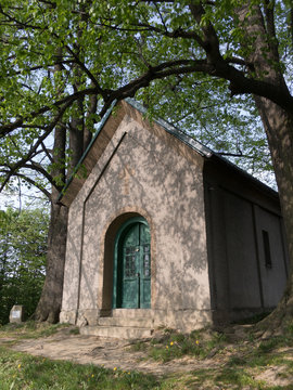 Christian chapel, Jablunkov Navsi, Czech Republic / Czechia - small and little religious and sacral building. Shadow over frontal wall and door in the evening