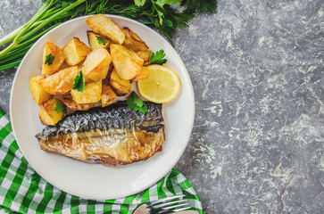 baked fish mackerel and potatoes. Selective focus.  