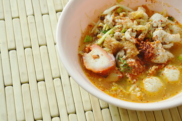 spicy boiled slice barbecue pork and ball in Tom Yum soup on bowl