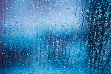 Naklejka na ściany i meble water drops of rain on a window glass. Rainy day