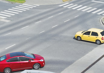 Fototapeta na wymiar Intersection with Yellow and Red Car