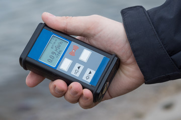 Man checking radiation with geiger counter