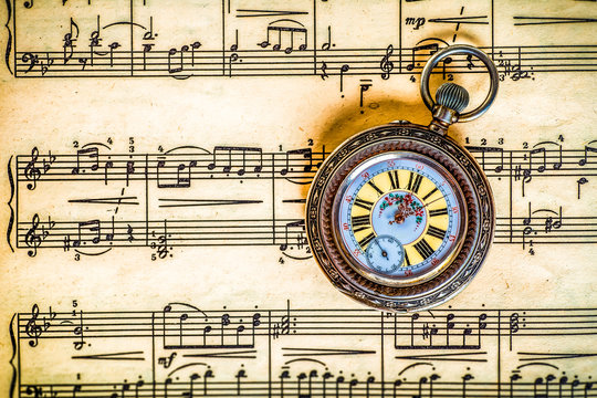 Vintage pocket watch on musical notes