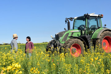 couple of farmers looking at a field