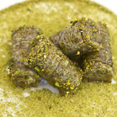 Traditional oriental dessert - baklava with pistachios and walnuts. Isolated