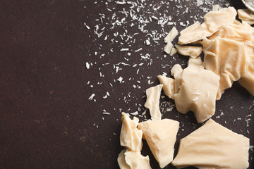 Crushed white chocolate pieces and coconut flakes on gray background