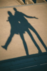 The shadow of the couple on the floor. Silhouette of the shadows on the asphalt