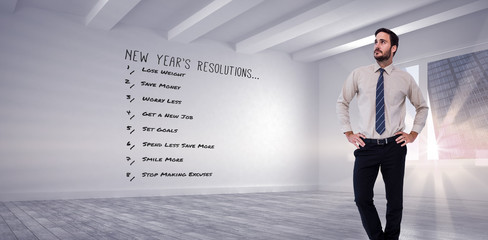 Obraz premium Businessman standing with hands on hips against white big room with windows