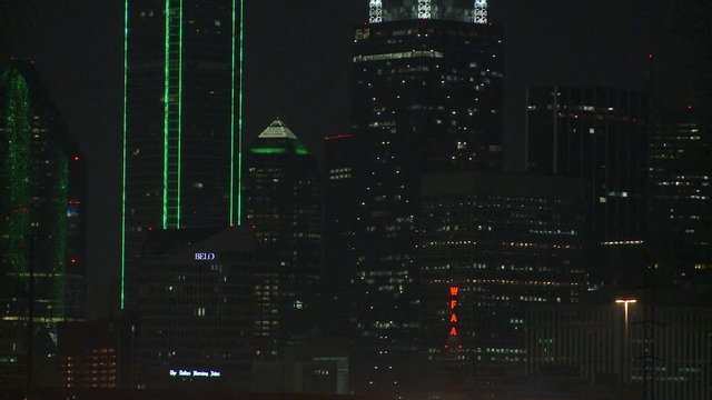Slow zoom-out from skyscrapers of downtown Dallas at night