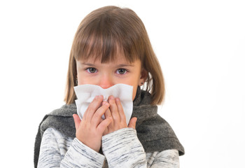 Sick girl with handkerchief at the home, on the white isolated background.