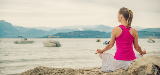 Woman meditating at the lake