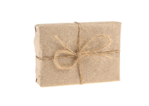 a box wrapped in gray paper with a rope on a white background