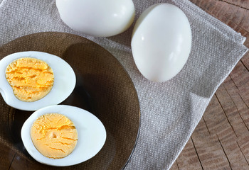 Boiled egg on a wooden background. Kind from above.