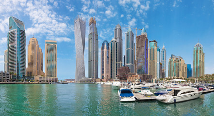 Fototapeta na wymiar DUBAI, UAE - MARCH 24, 2017: The skyscrapers of Marina and the yachts.