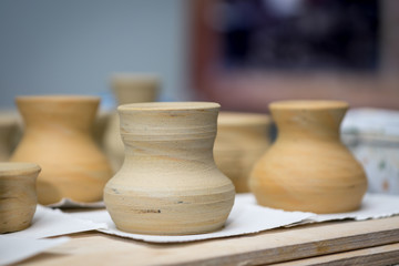 Fototapeta na wymiar ceramic vases and pots made on a Potter's wheel dry in the process of manufacture
