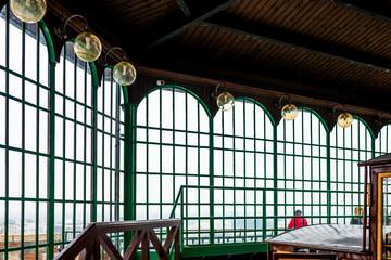 glass arched windows with round wall lamps