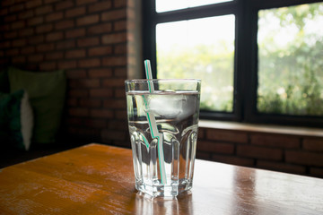 glass of mineral water on wood table in restaurant