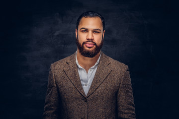 Obraz premium Handsome bearded African-American businessman in a brown classic jacket.