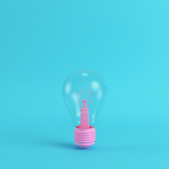 Pink light bulb on bright blue background in pastel colors. Minimalism concept