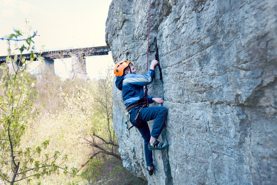 Kid Rock Climber Climbs The Cliff.